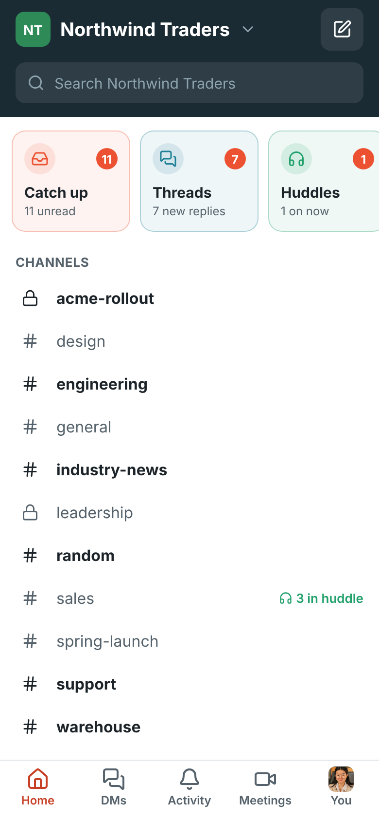 Home on a phone: the row of Catch up, Threads and Huddles tiles with their counts, above the channels and direct messages